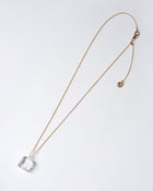 Delicate transparent glass pieces reminiscent of melting ice, paired with an adjustable gold‑plated necklace chain.