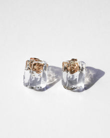 Clear glass fragments reminiscent of melting ice, catching the light on gold‑plated stud posts.