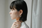 Gold‑plated stud earrings with layered sheets of transparent glass draped like ice over branches, etched with fine lines that sparkle in the light.