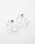 Gold‑plated stud earrings with layered sheets of transparent glass draped like ice over branches, etched with fine lines that sparkle in the light.
