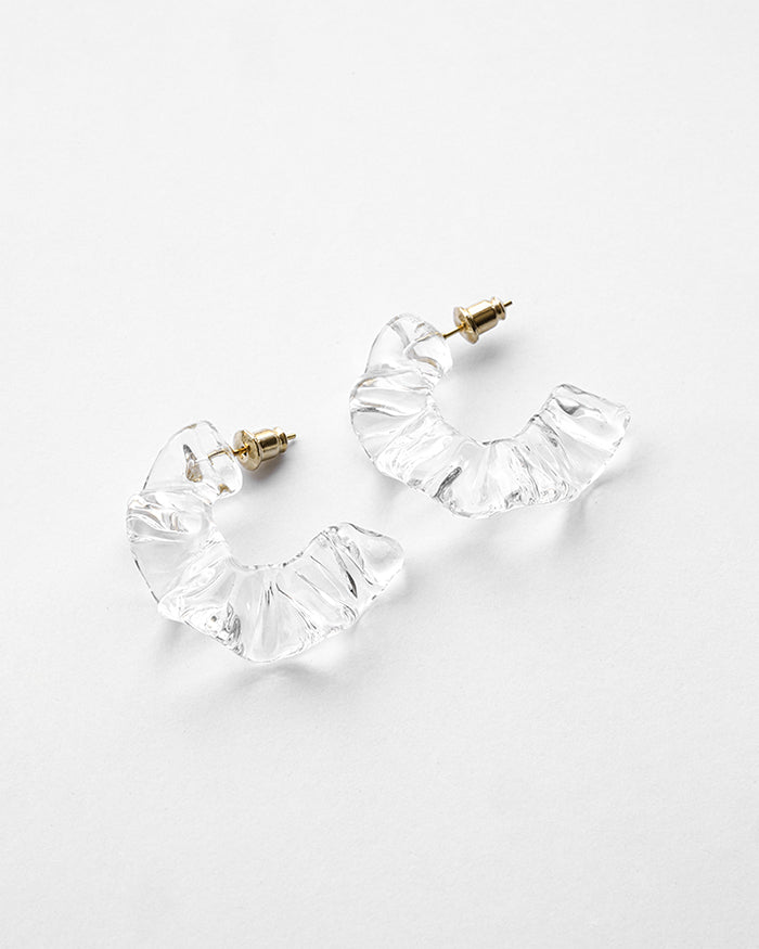 Gold‑plated stud earrings with layered sheets of transparent glass draped like ice over branches, etched with fine lines that sparkle in the light.