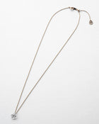A small hydrangea-shaped glass pendant in soft gray, attached to a brass chain with nickel-free gold plating and an adjustable slide ball.