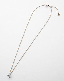 A small hydrangea-shaped glass pendant in soft gray, attached to a brass chain with nickel-free gold plating and an adjustable slide ball.