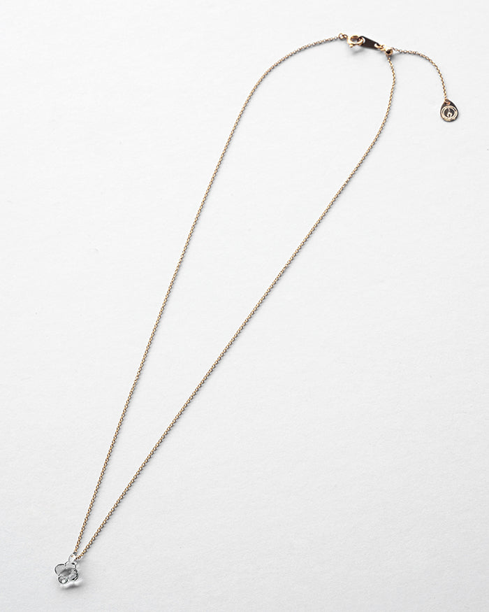 A small hydrangea-shaped glass pendant in soft gray, attached to a brass chain with nickel-free gold plating and an adjustable slide ball.