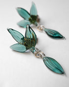 Earrings inspired by the vitality of fresh spring foliage. Delicate leaf‑shaped glass pieces sway gently from stud posts, as if light has been softly lifted from overlapping green leaves and transformed into jewelry.