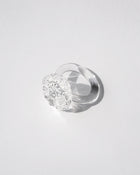 “A handmade transparent glass ring accented with a single, intricately formed glass flower.