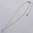 “A soft cube-shaped handmade glass pendant combining textured frosted and smooth surfaces, attached to a 500mm gold plated necklace chain with an adjustable ball clasp.
