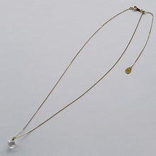 “A soft cube-shaped handmade glass pendant combining textured frosted and smooth surfaces, attached to a 500mm gold plated necklace chain with an adjustable ball clasp.