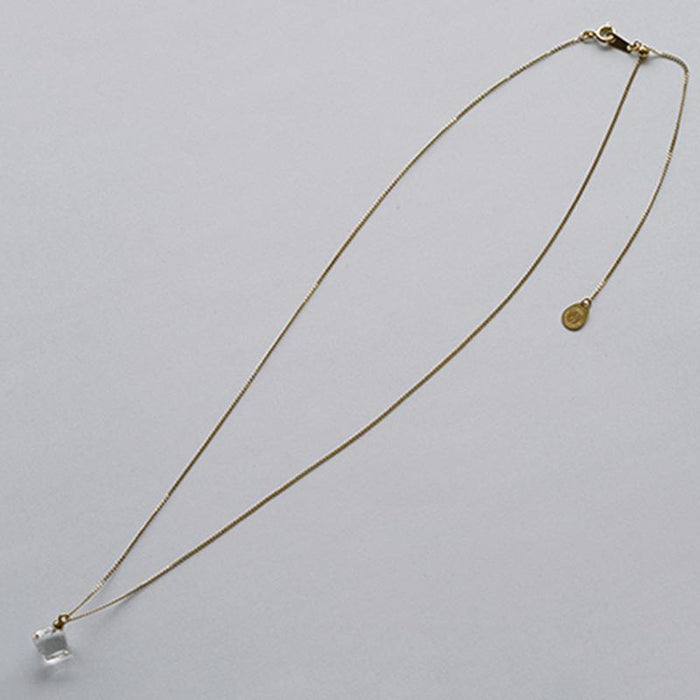 “A soft cube-shaped handmade glass pendant combining textured frosted and smooth surfaces, attached to a 500mm gold plated necklace chain with an adjustable ball clasp.