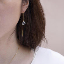 Softly shaped glass cube earrings that feature contrasting frosted and polished surfaces. Handmade melted-look glass cube earrings attached to slender gold-plated chains designed to be threaded through the piercing.