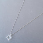 A soft square handmade glass pendant that glows like moonlight, attached to a 470mm silver necklace chain.