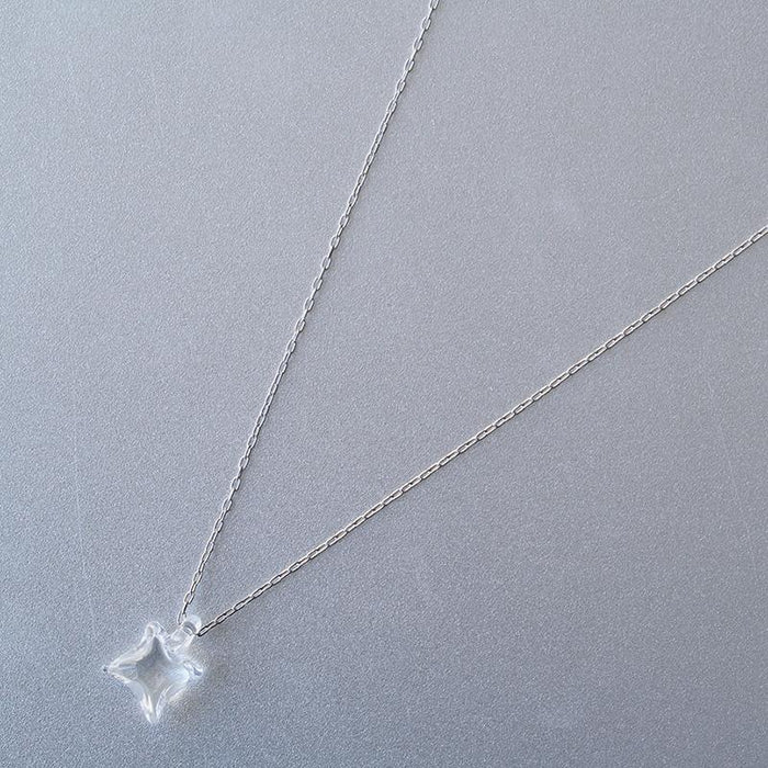 A soft square handmade glass pendant that glows like moonlight, attached to a 470mm silver necklace chain.