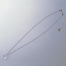 A soft square handmade glass pendant that glows like moonlight, attached to a 470mm silver necklace chain.