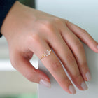 “A gold-plated adjustable ring featuring a soft cube-shaped glass element with contrasting frosted and smooth surfaces that evoke moonlight.