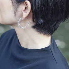 Delicate gold‑plated stud earrings with luminous spiral glass that glimmers beautifully from every angle.