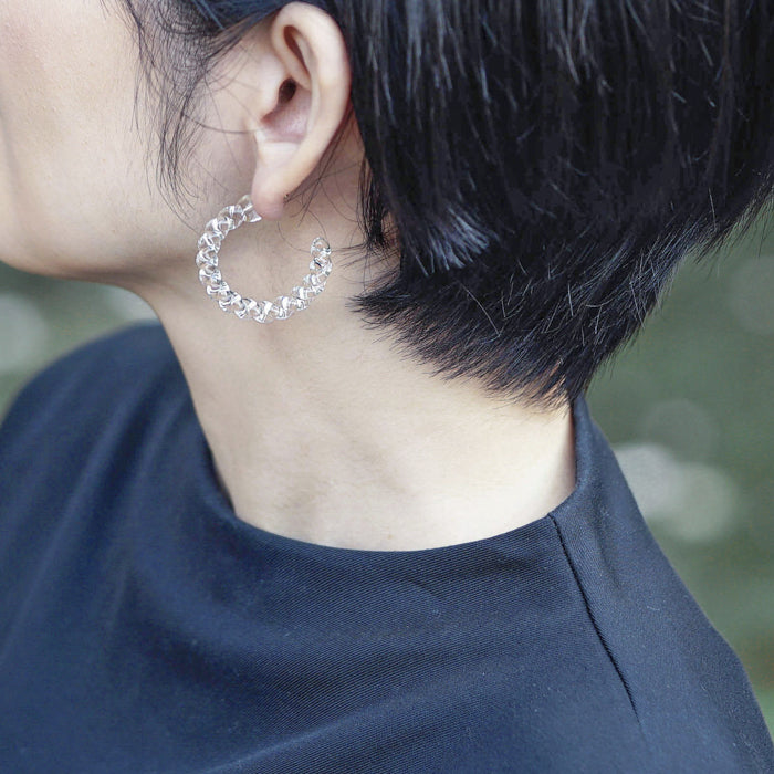 Delicate gold‑plated stud earrings with luminous spiral glass that glimmers beautifully from every angle.