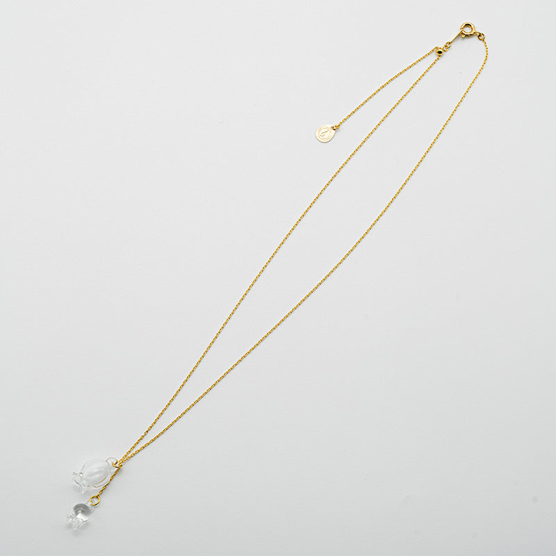 A handmade glass lily pendant with one flower and one bud, suspended from an adjustable gold‑plated chain.