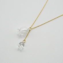 A handmade glass lily pendant with one flower and one bud, suspended from an adjustable gold‑plated chain.
