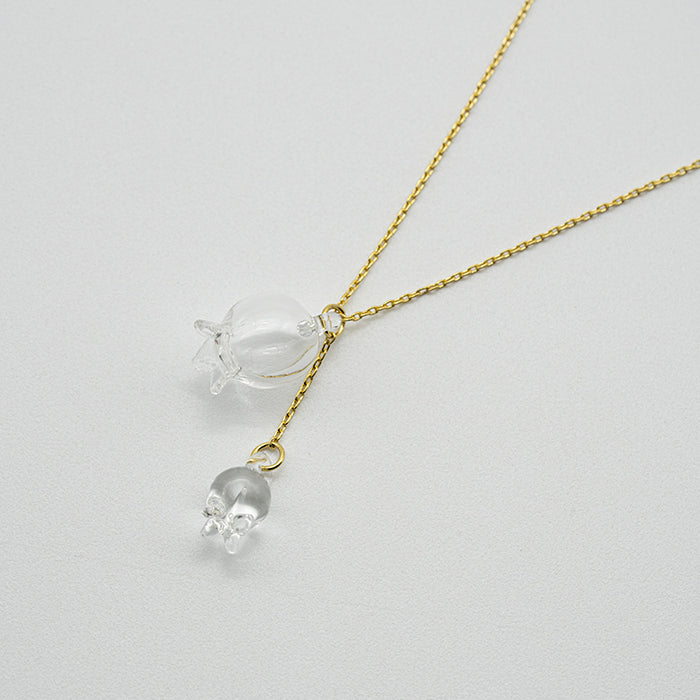 A handmade glass lily pendant with one flower and one bud, suspended from an adjustable gold‑plated chain.