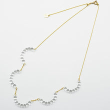A necklace made of five connected arcs that resemble softly rounded water droplets, attached to a gold‑plated chain with an adjustable sliding ball.